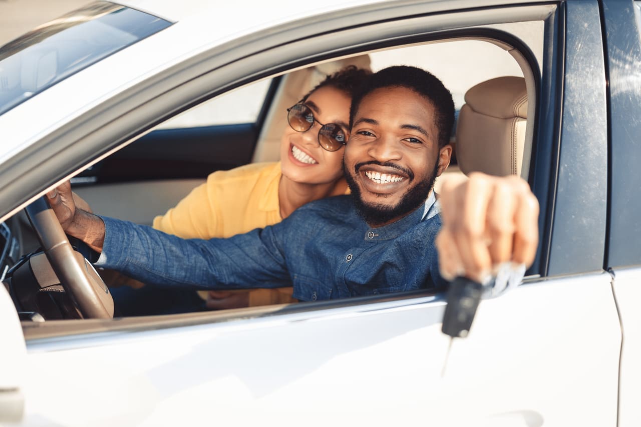 Couple in new car purchased with an auto loan