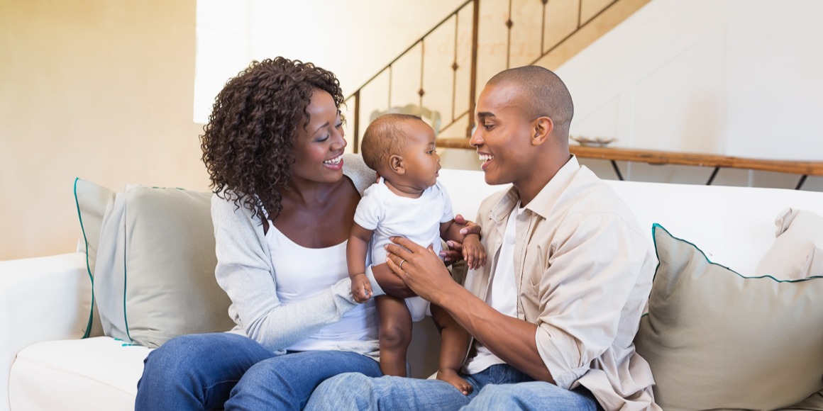 Financial Readiness Guide for New Parents family sitting with baby