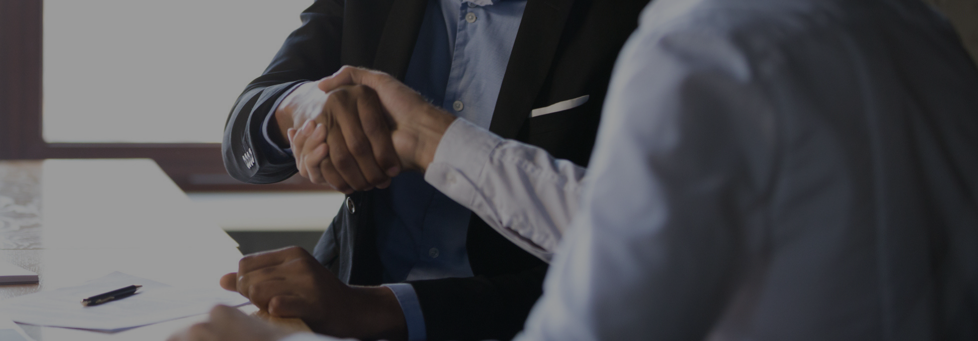 Business Professionals shake hands. 