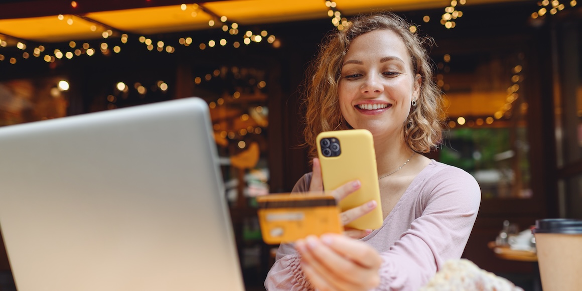 Smiling young woman holding up a First State Community Bank credit card