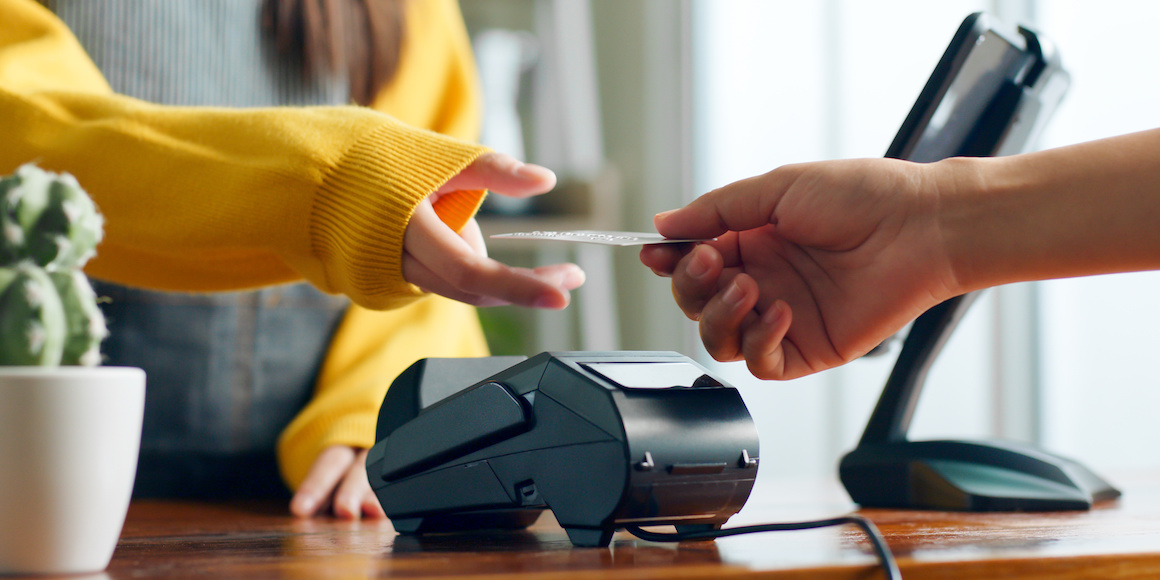 Someone making a purchase at a store with their FSCB debit card so they can maximize their entries in FSCB Grand Giveaways