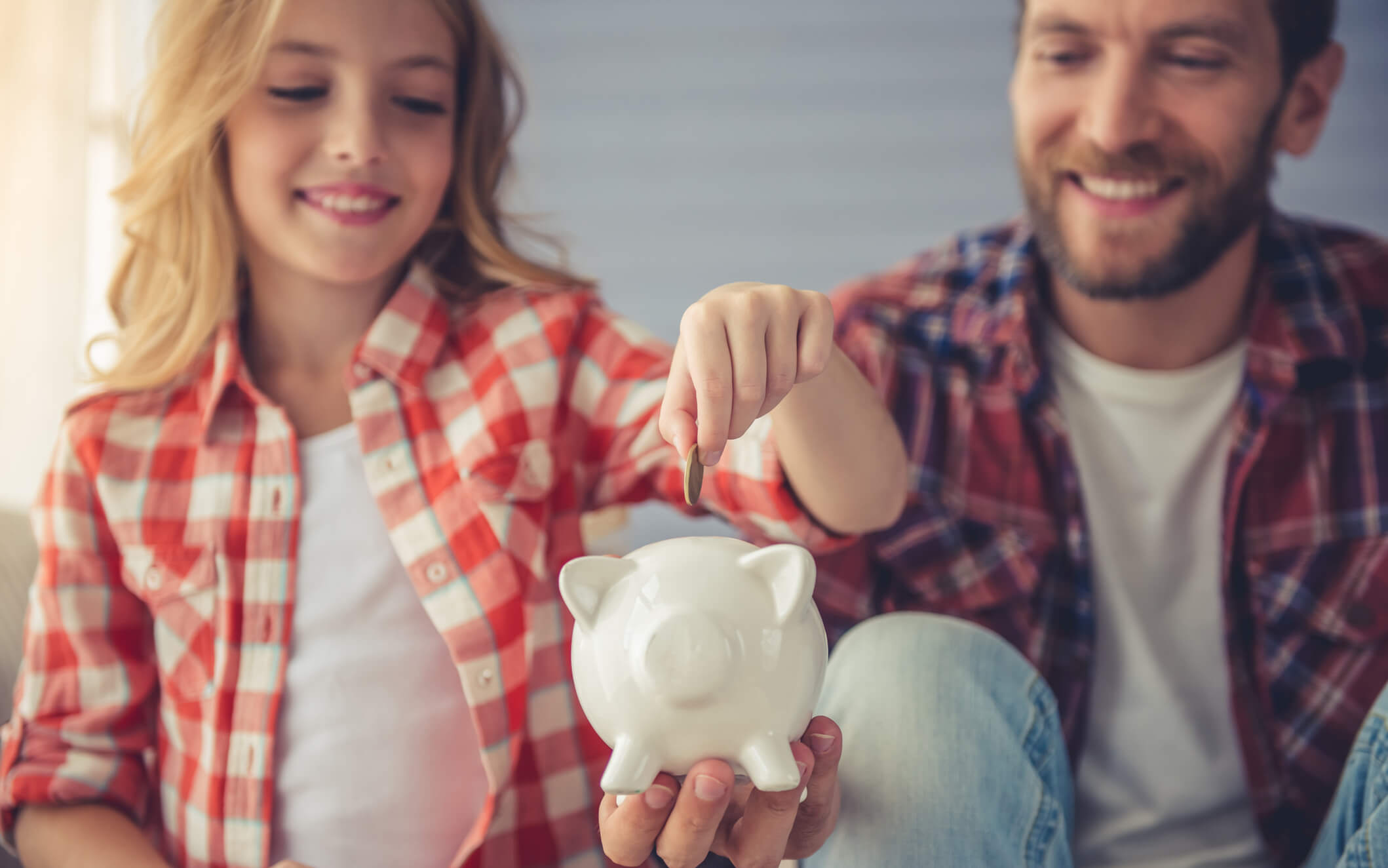Father talking to daughter about money and savings.