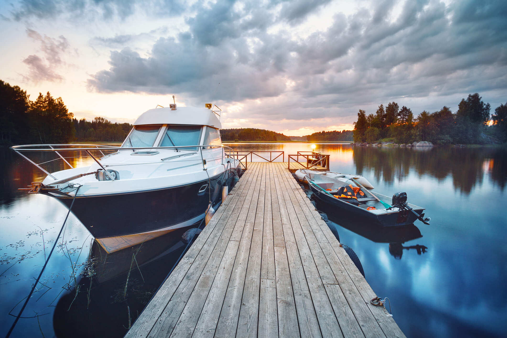 Dock with lake boat on the left and fishing boat on the right, both paid for with boat loans